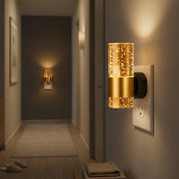 LED night light glowing warmly in a hallway at night